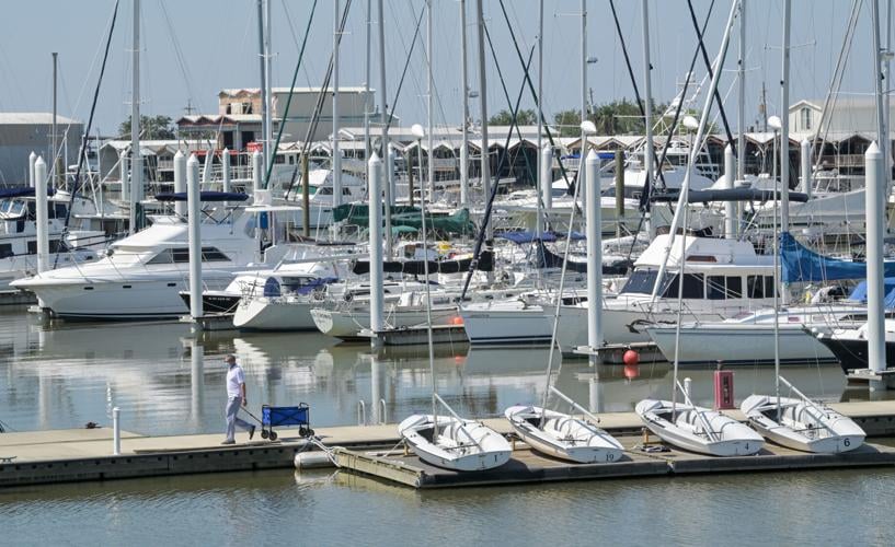 Sailboats and motorboats docked at a marina in New Orleans