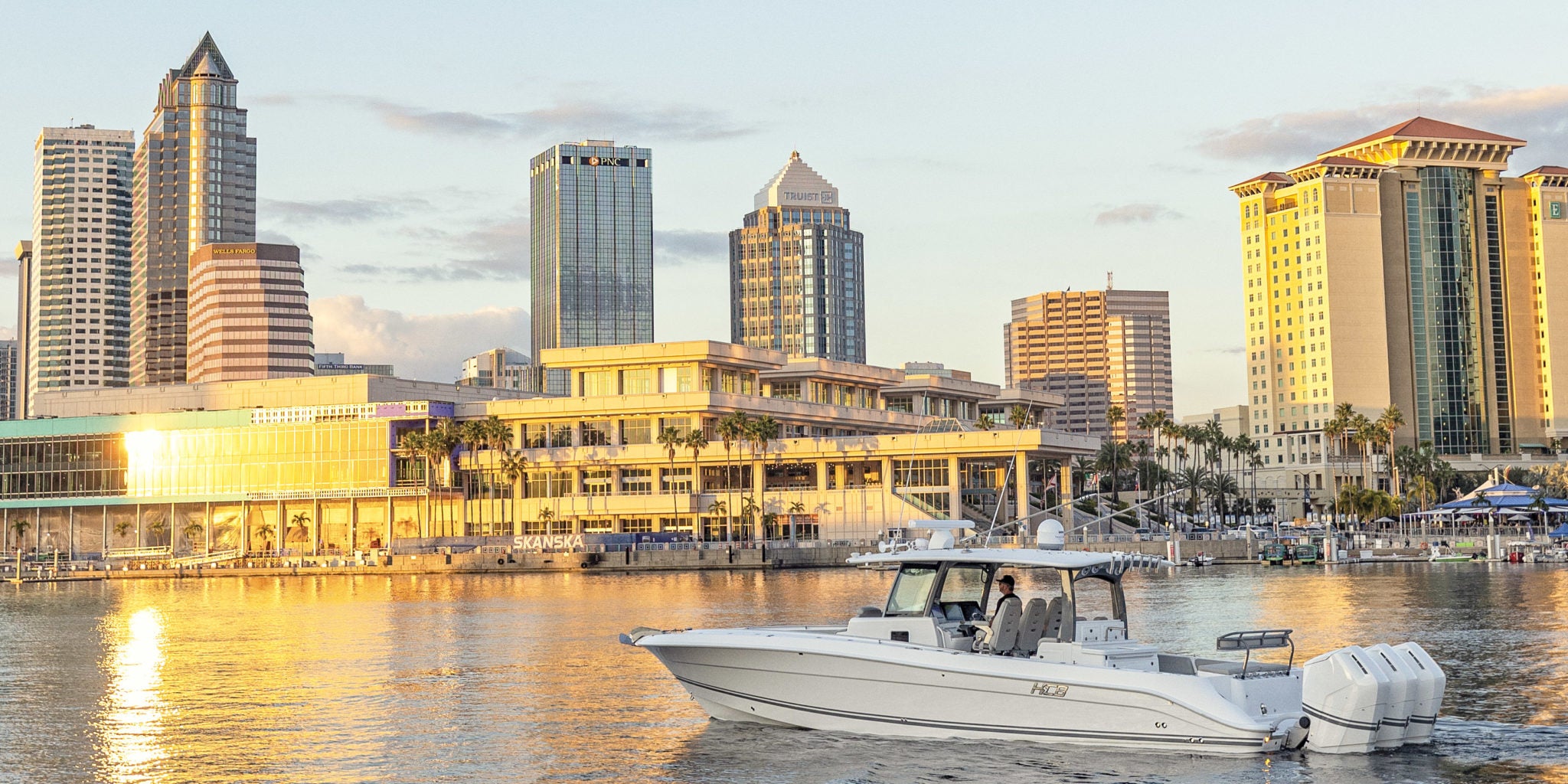 Boat cruising on Tampa Bay with the Tampa skyline behind